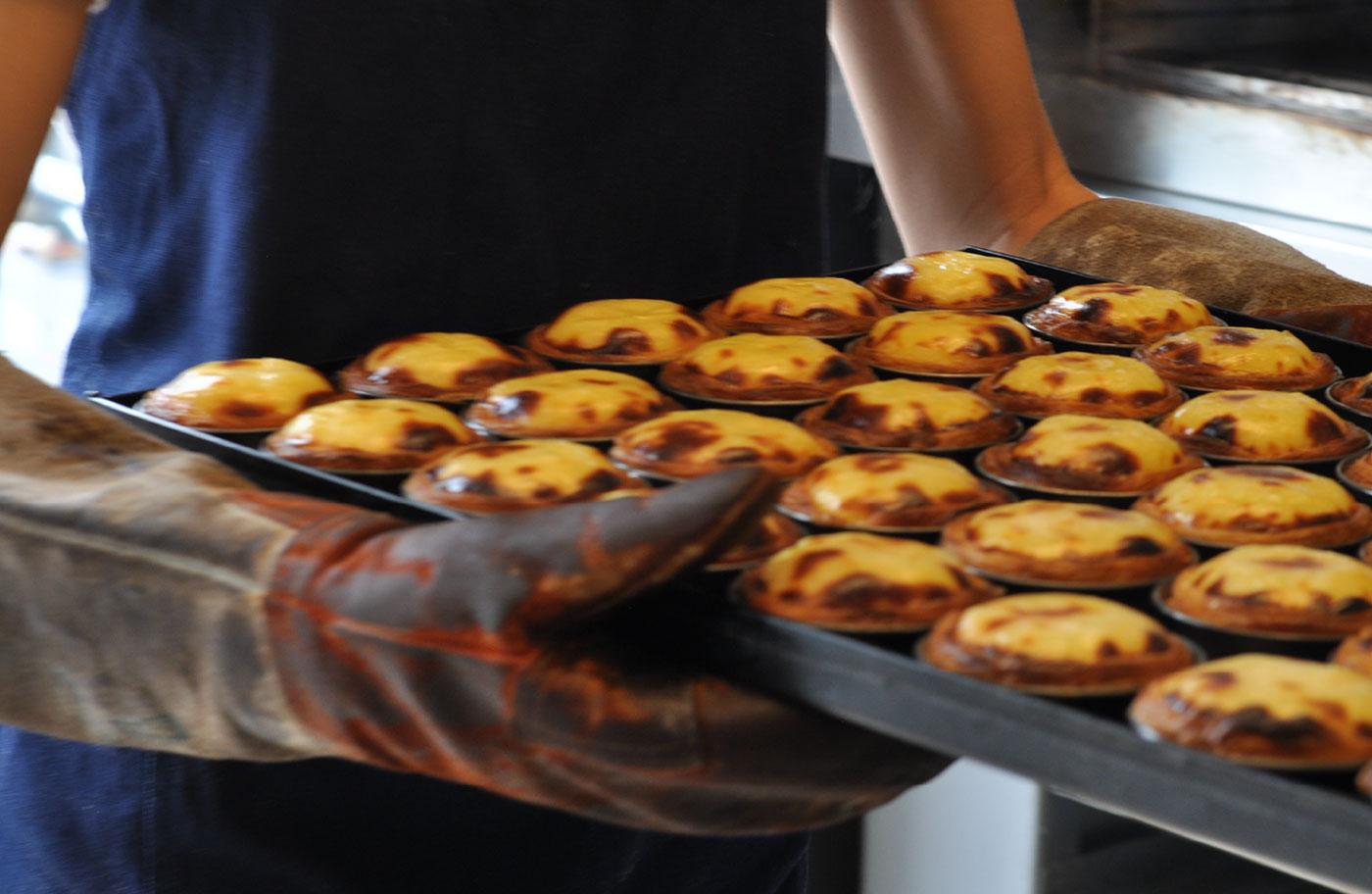 Person carrying Portuguese Tarts
