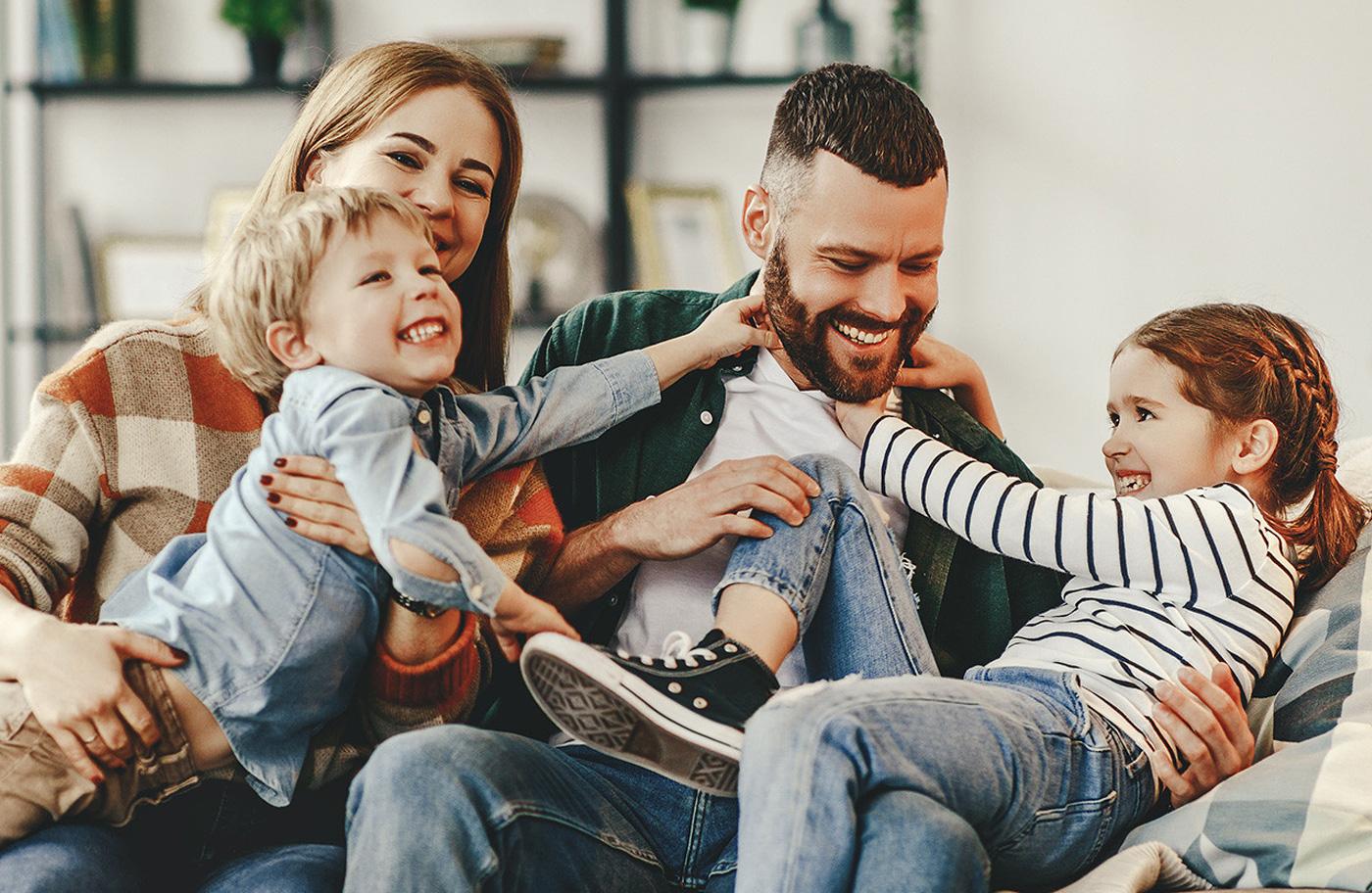 Happy family playing at Olive Wood